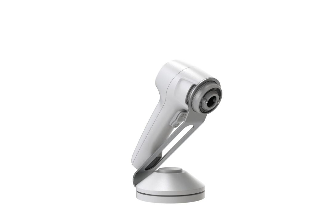 Compact aesthetic handpiece on a stand