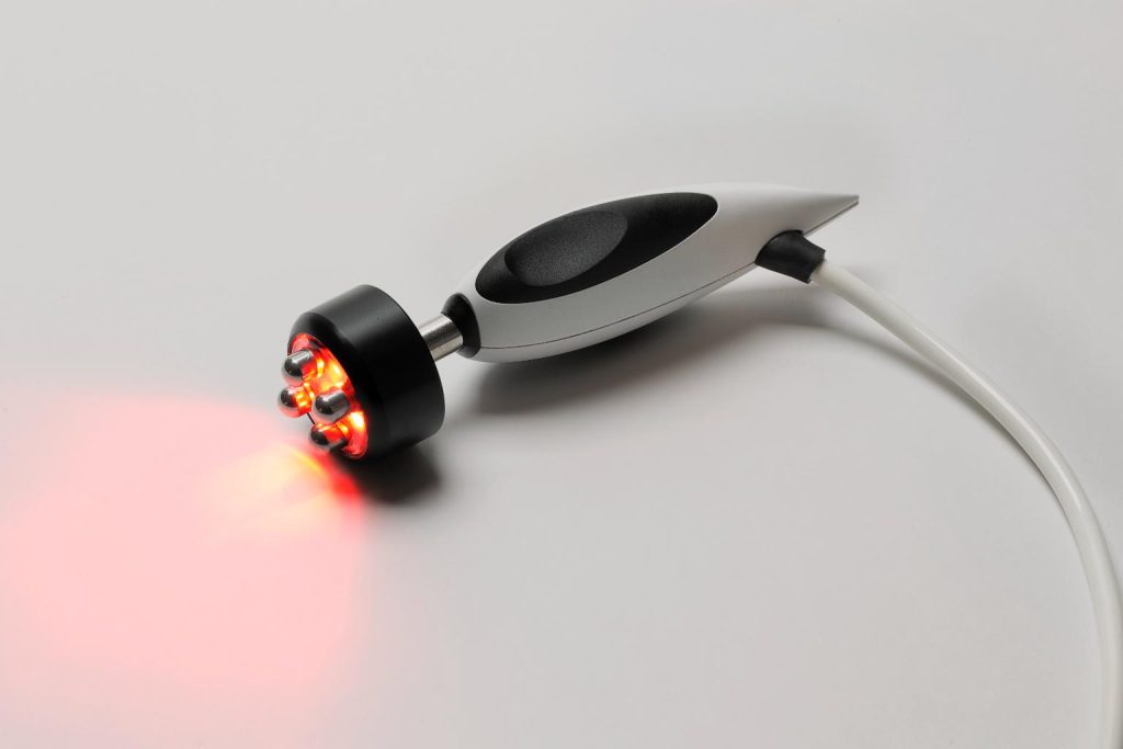Aesthetic handpiece emitting red LED light with roller heads