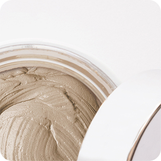Close-up of a beige clay cream mask in an open jar