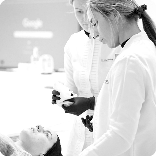 Black-and-white photo of a practitioner treating a reclining client