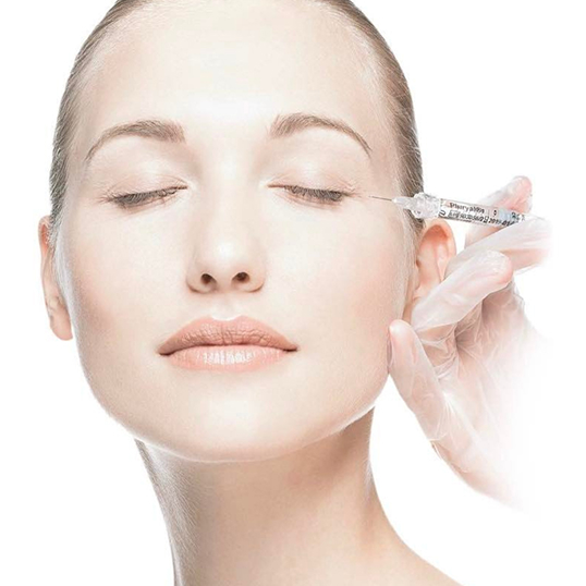 Woman receiving an injection near her jawline with eyes closed