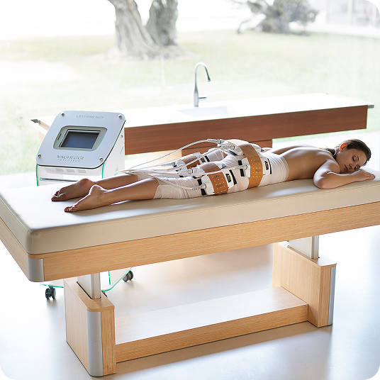 Person on a spa table with body-contouring electrode bands