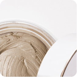 Beige clay cream mask in an open jar
