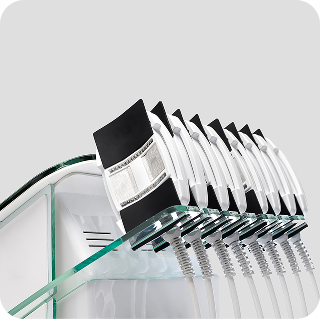Row of aesthetic treatment handpieces displayed on a glass shelf