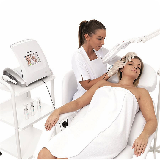 Therapist performing a facial device treatment on a reclining client