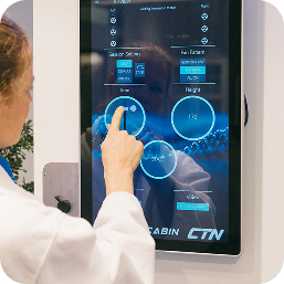 Hand operating a cabin's digital touchscreen control panel