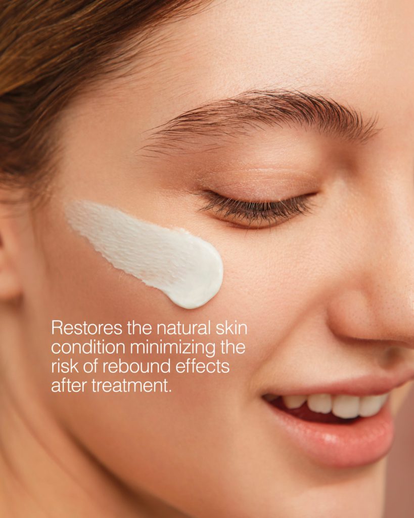 Close-up of a woman's face with white treatment cream on her cheek