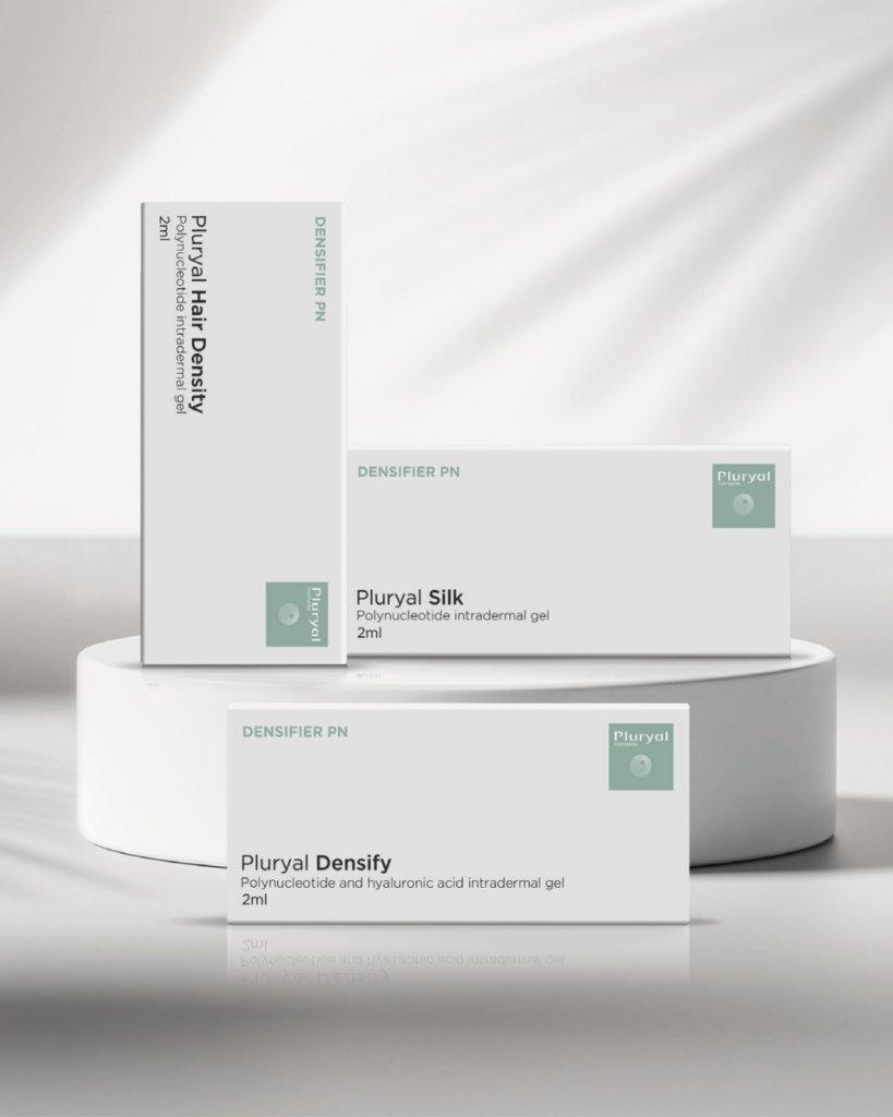 Pluryal Silk and Density dermal-filler boxes on a display podium
